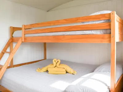 a stuffed animal laying on top of a bunk bed at Jamie's Shepherds Hut - Uk43566 in Bowness-on-Solway
