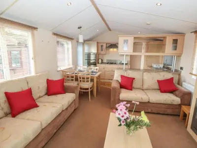 a living room with two couches and a table with red pillows at Stanleys Sanctuary, Lake District in Plumbland