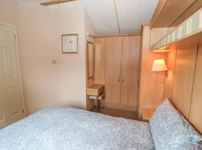 a small bedroom with a bed and a desk at Stanleys Sanctuary, Lake District in Plumbland