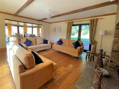 a living room with two couches and a fireplace at Beautiful 5BR House near Gretna Green with Garden - Pass the Keys in Kirkpatrick Durham