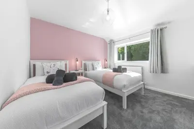 a bedroom with two beds and a window at Brundholme House in Keswick
