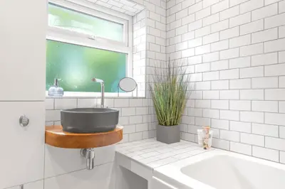 a bathroom with a sink and a bath tub at Brundholme House in Keswick