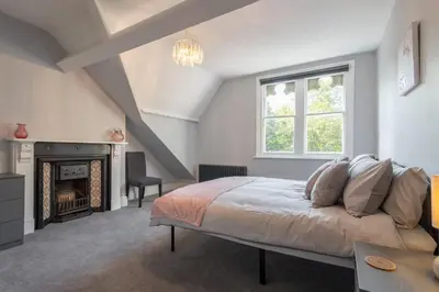 a bedroom with a bed and a fireplace at Host & Stay - Chatsworth Townhouse I in Carlisle