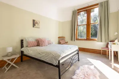 a bedroom with a bed with pink pillows and a window at Host & Stay - Chatsworth Townhouse II in Carlisle