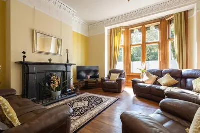 a living room with leather furniture and a fireplace at Host & Stay - Chatsworth Townhouse II in Carlisle
