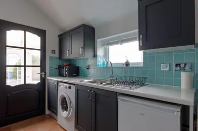 a kitchen with a sink and a washing machine at The Paddock at Brickrow Farm in Ayr