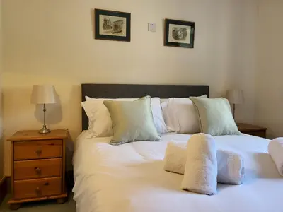 two beds sitting next to each other in a bedroom at Wheelwrights House in Ambleside