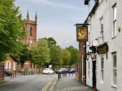 a sign on the side of a building on a street at Stanwix Cottage in Carlisle