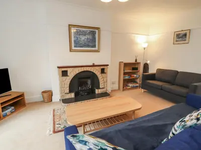 a living room with a couch and a fireplace at Burnbank in Maryport
