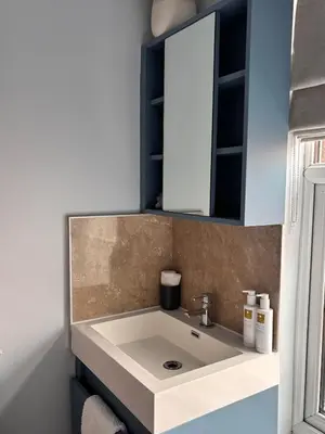 a bathroom with a white sink and a mirror at Cartref Guest House in Carlisle