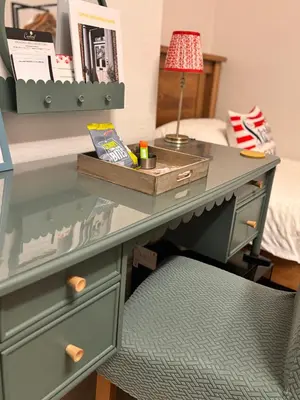 a desk with a chair and a desk with a lamp at Cartref Guest House in Carlisle