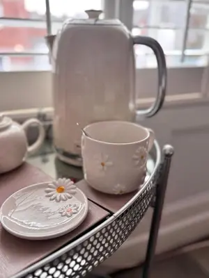 a tea cup and saucer on a table at Cartref Guest House in Carlisle
