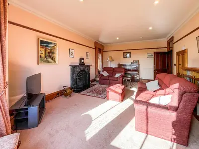 a living room with two couches and a television at Kirkdale in Kirkton