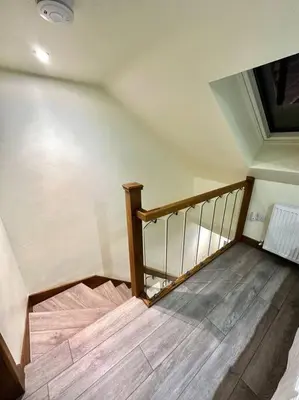 a staircase in a room with a wooden floor at The Anne'x in Dalbeattie