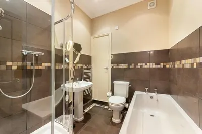 a bathroom with a toilet and a tub and a sink at Langdale Crag in Grasmere