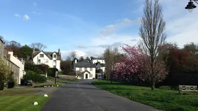 a street in a residential neighborhood with white houses at The Shack, Cally Avenue, Gatehouse of Fleet, Dumfries and Galloway, DG7 2 DH in Gatehouse of Fleet