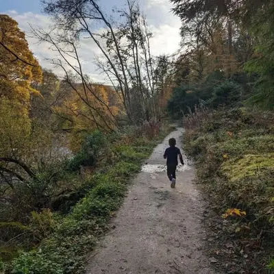a young boy walking down a dirt road at Luxurious Georgian Town House in Langholm