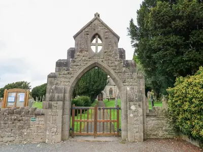 an entrance to a stone building with a gate at John Duftons Barn in Cockermouth