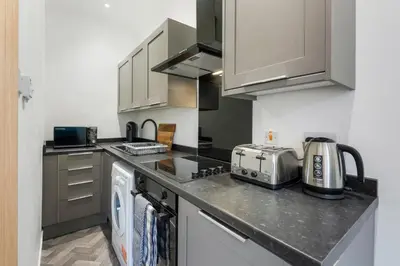 a kitchen with a counter top with a appliance at George St Getaway in Ayr