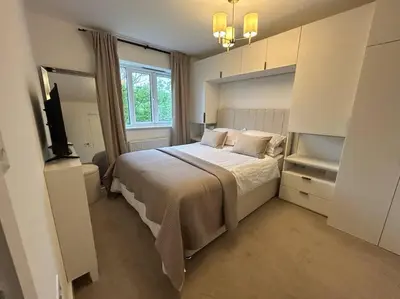 a bedroom with a large bed and a window at Lake District Haven - Modern Comfort in Cockermouth in Cockermouth