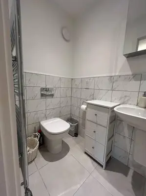 a small bathroom with a toilet and a sink at Lake District Haven - Modern Comfort in Cockermouth in Cockermouth