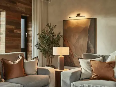 a living room with two chairs and a painting at Eskdale Retreat in Holmrook