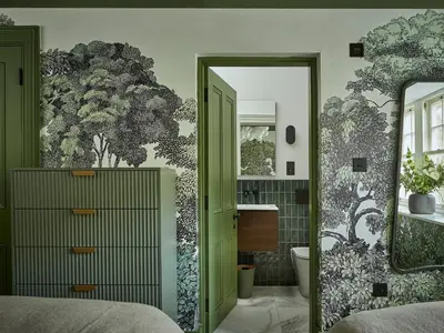 a bedroom with a green door and a green wall at Eskdale Retreat in Holmrook