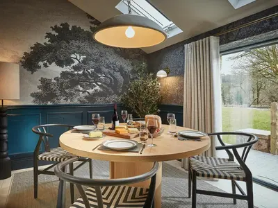 a dining room with a wooden table and chairs at Eskdale Retreat in Holmrook