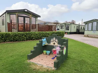 a statue of a sandbox in the yard of a house at Highlands Way Lodge in Workington