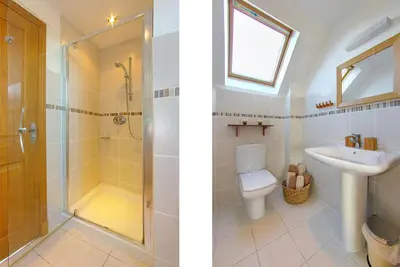 a bathroom with a shower and a sink and a toilet at Inchlonaig House in Port William