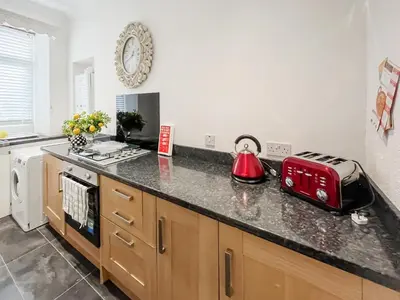 a kitchen with a counter with a toaster on it at Beachcomber Apartment in Girvan