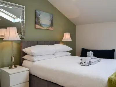a bedroom with a bed with a stuffed animal on it at Tiberius Claudius Augustus Suite - Uk43559 in Bowness-on-Solway