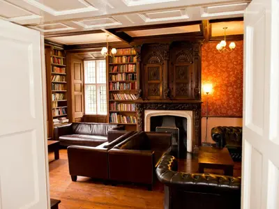 a living room with a couch and a fireplace at YHA Wasdale Hall in Nether Wasdale