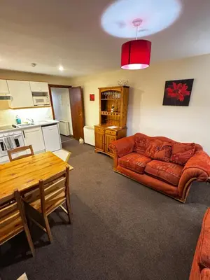 a living room with a couch and a table at The Wasdale Head Inn & Apartments in Seascale