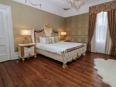 a bedroom with a bed and two tables with lamps at Beechgrove Manor in Workington