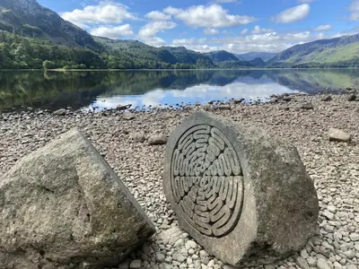 a rock with a design on it next to a body of water at 2 Bed in Keswick 95741 in Keswick