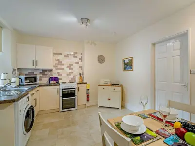 a kitchen with a sink and a stove top oven at 2 Bed in Keswick 95741 in Keswick