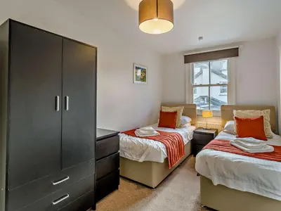 a bedroom with two beds and a cabinet and a window at 2 Bed in Keswick 95741 in Keswick