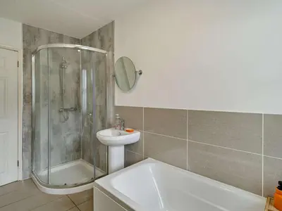 a bathroom with a shower and a sink and a tub at 2 Bed in Keswick 95741 in Keswick