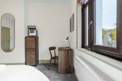 a bedroom with a desk and a chair next to a window at Boutique Home in Lake District, West Cumbria in Workington