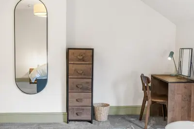 a bedroom with a desk and a mirror at Boutique Home in Lake District, West Cumbria in Workington