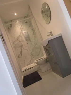 a bathroom with a marble shower and a toilet at Oak End Stay in Carlisle
