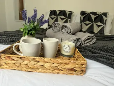 a tray with cups and candles on a bed at Robinson's Retreat - Cockermouth - Lake District in Cockermouth