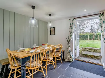a dining room with a wooden table and chairs at 4 Bed in Keswick oc-95739 in Bassenthwaite