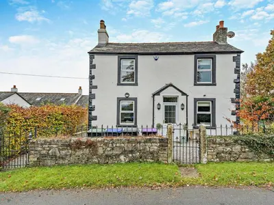 a white house with a fence in front of it at 4 Bed in Keswick oc-95739 in Bassenthwaite