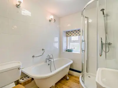 a bathroom with a tub and a shower and a sink at 4 Bed in Keswick oc-95739 in Bassenthwaite