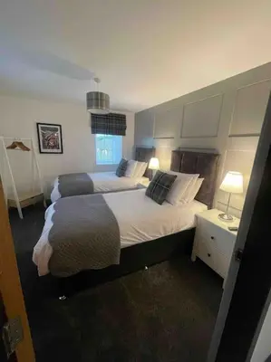 a large bedroom with two beds and two lamps at Watchhall, Annan, Dumfries & Galloway, Scotland Barn - 2 Bed in Annan