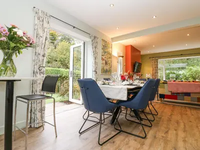 a kitchen and dining room with a table and chairs at Esk Brae in Langholm