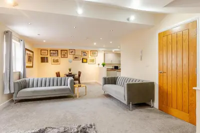 a living room with two couches and a door at John Dalton House in Cockermouth