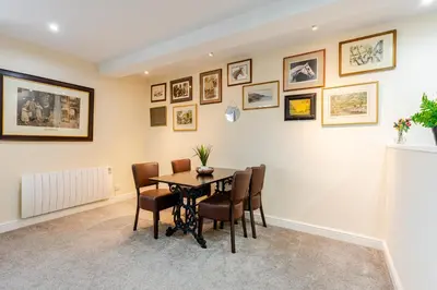 a dining room with a table and chairs at John Dalton House in Cockermouth